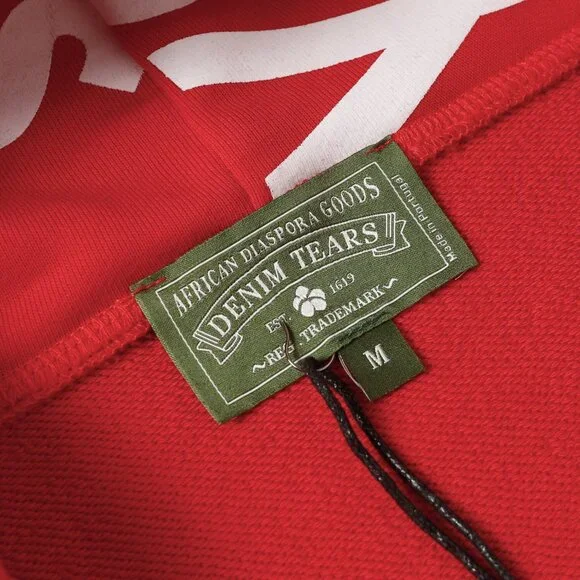 Red lettering Denim Tears zip-up hooded jacket